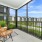 Screened in apartment patio with a view of the community pond at NOVO Avian Pointe
